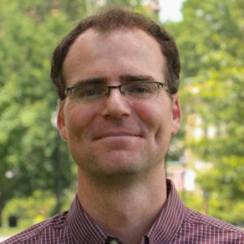 Portrait of Dr. Isaac Larsen, smiling at camera