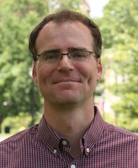 Portrait photo of Isaac Larsen looking at camera, smiling.